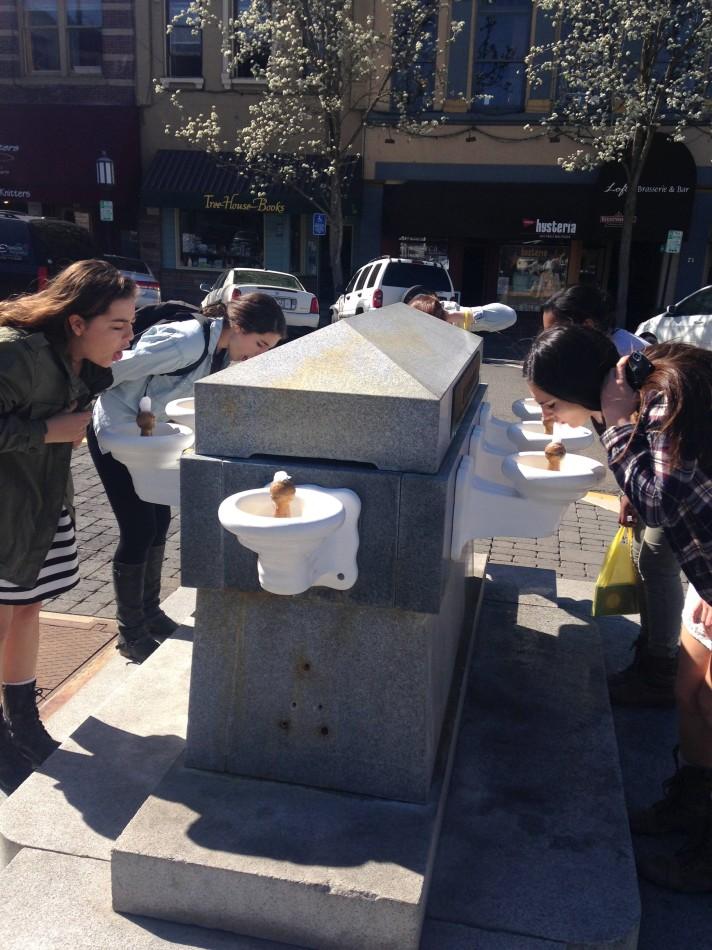 A few students drink from the traditional Lithia water fountain.