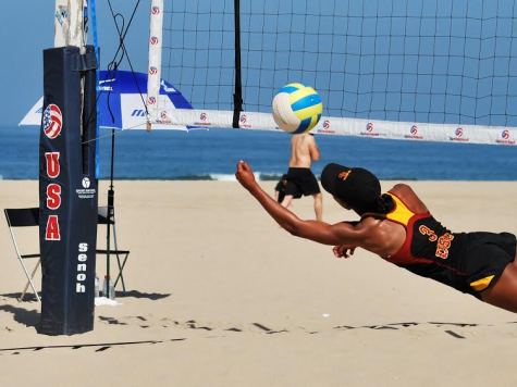 Collegiate beach volleyball is emerging into the spotlight of college sports.  NCAA finally recognized beach volleyball as a college sport and is now helping it transition from an emerging sport to a Championship sport.  A college player for USC dove for a stray ball at one of the first college beach volleyball tournaments.