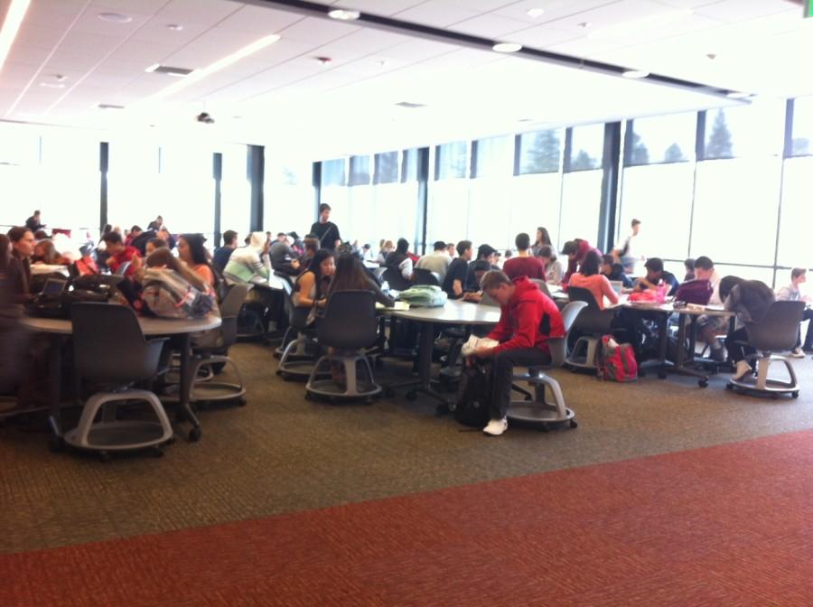 Students crowd the Workday Student Center during lunchtime. No food is allowed here, so what are these kids doing? Not eating.