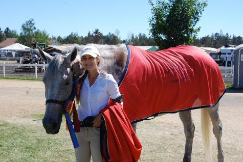 Kelsey Sarracino poses at a tournament with her horse, Kai. She bought him this past spring in Canada.
(Courtesy of John Sarracino)