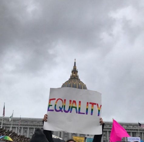 Civic Center Plaza, San Francisco- Gay Straight Alliance (GSA) 
member senior Erin Yoshina raises up her homemade poster,
heading towards Market Street for the SF march.