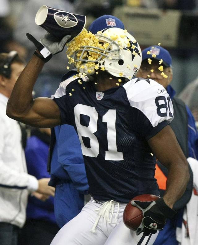 Dallas Cowboys wide receiver Terrell Owens, celebrates a touchdown by pouring popcorn on his face.