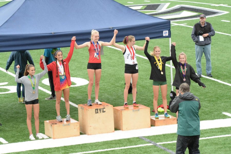 Senior Kelli Wilson stands in the middle of the podium, grinning as she wins NCS in the 3200-meter race. She committed to Duke University in October and will run for the cross country and track teams in the fall. 