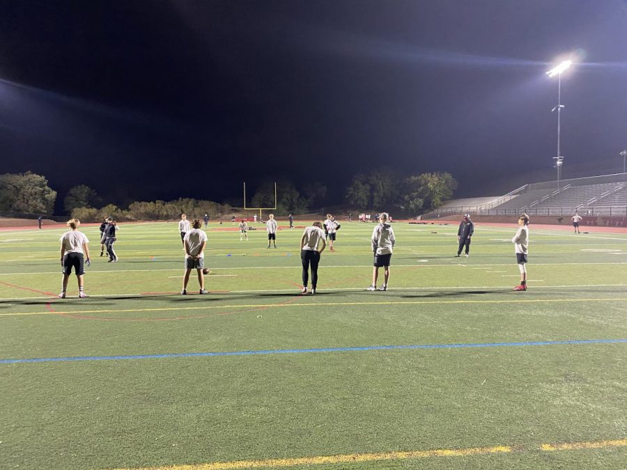 Monte+Vista+freshman+football+coach+Eric+Nystrom+wears+a+mask+while+making+sure+the+rest+of+the+players+are+remaining+distanced+during+conditioning.