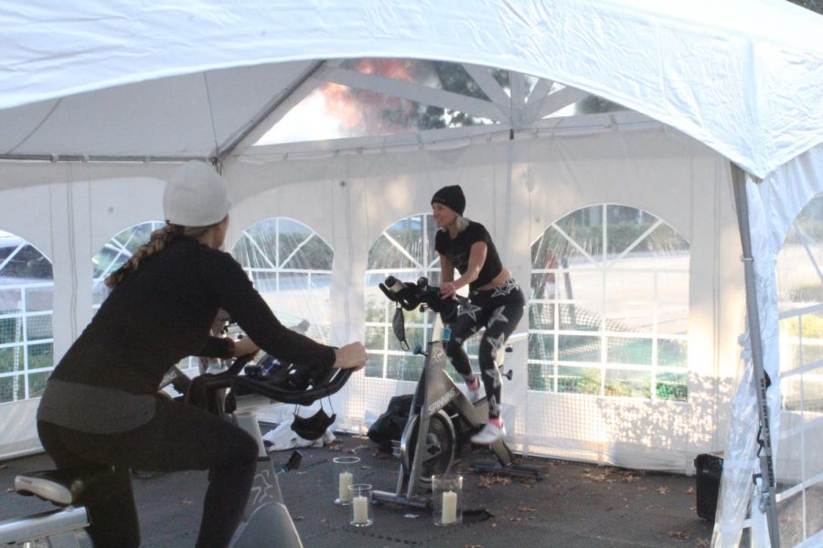 Jenn Soine, the owner of Star Cycle, instructs the riders of the 7:45 a.m. outdoor spin class. Although temperatures were borderline freezing, Soine continues the outdoor rides to ensure the comfort and safety of all participants. The bikes are six to eight feet apart and customers are required to use hand sanitizer before entering the makeshift studio. 