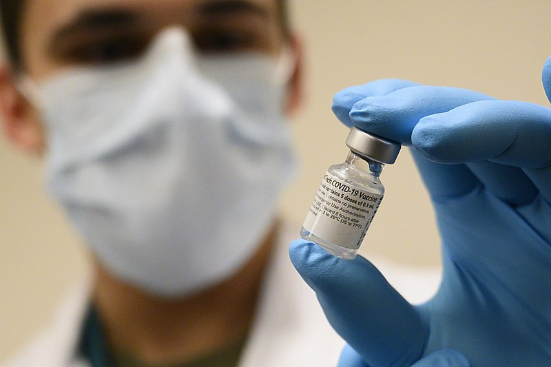 A U.S. Army Specialist prepares a vial of the Pfizer-BioNTech COVID-19 vaccine on Dec. 14, 2020, near the first phase of vaccinations for high-risk health workers and first responders.