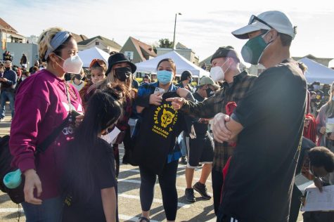 Attendees converse at a rally in Oakland on Feb. 13. The rally was
held to promote healing and show support for victims of recent attacks
against Asian-Americans.
