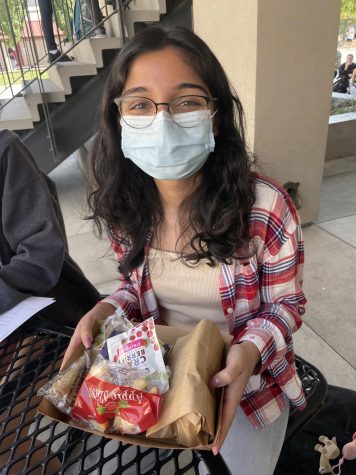 Senior Sabeeka Qureshi enjoying her free school lunch. Her favorite item was the bean burrito and apple slices. 