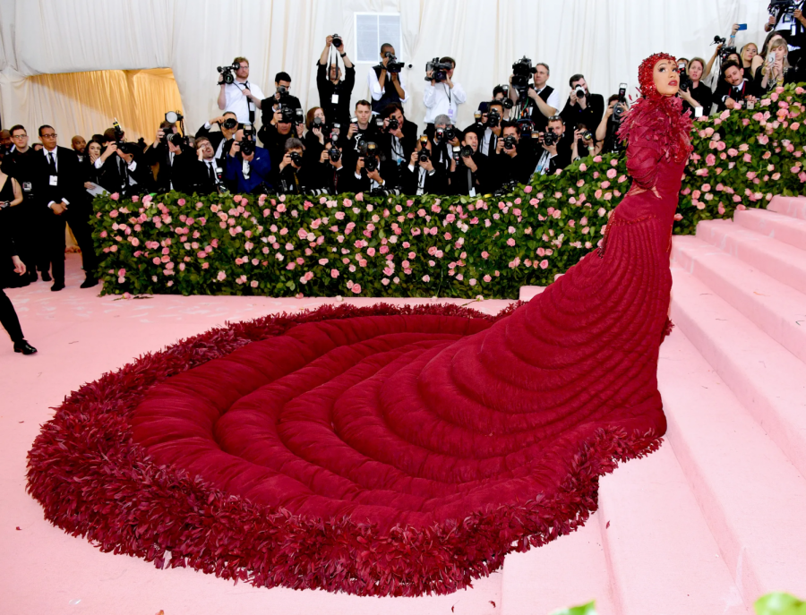 American+Rapper+Cardi+B+posing+for+the+paparazzi+at+the+2019+Camp+themed+Met+Gala.+Her+gown%2C+by+Thom+Browne%2C+featured+endless+amounts+of+silk+organza+and+feathers.+
