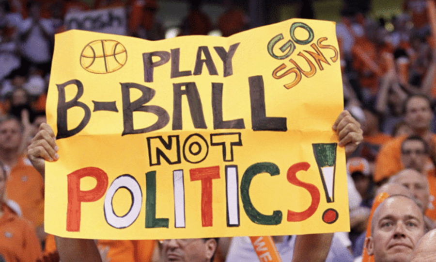 A Phoenix Suns fan makes his opinion heard with a bold sign protesting politics in sports. The motive behind the sign stems from the teams decision to wear Los Suns jerseys years ago. 
