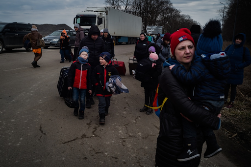 Ukrainian families fleeing Ukraine with their belongings. As the crisis in Ukraine escalates, many families left everything behind as they hold on to the hope that they can find a new home in a neighboring country.  