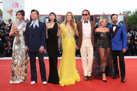 Director Olivia Wilde is pictured in the center of DWD’s cast at the Venice Film Festival, with actors separating Wilde from Harry Styles and Florence Pugh. This photo provoked talk of Styles, Wilde, and Pugh needing ‘human buffers’ between them at all times during the festival.