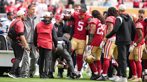 Trey Lance (5) being helped up after suffering a severe ankle injury. Lance has been ruled out for the 2022 season.