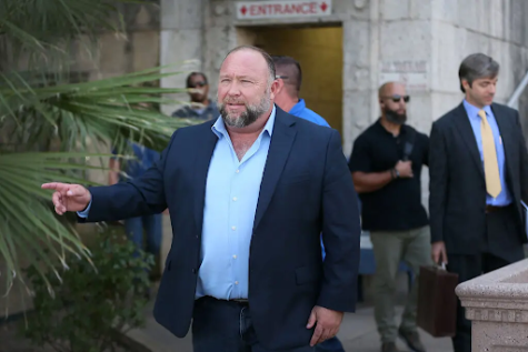 Alex Jones is pictured walking out of a courtroom in Austin, Texas. Jones had to pay a sum of 965 million dollars to the plaintiffs of his defamation case involving the Sandy Hook shooting.