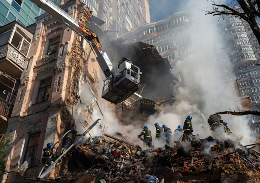 Ukrainian firefighters working to put out fires in Kyiv, the capital of Ukraine. The damage occurred after Russia sent a wave of suicide drones, employed with explosives, that destroyed many homes.