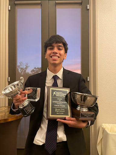 Amran Hudda posing after the 2022 Speech and Debate banquet. Hudda was awarded for his successful year.  