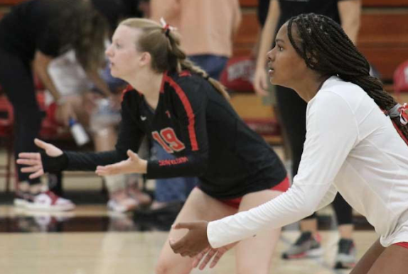 Kennedy Whyte on the court playing volleyball. She was getting ready to receive a serve from the opposing team. 
