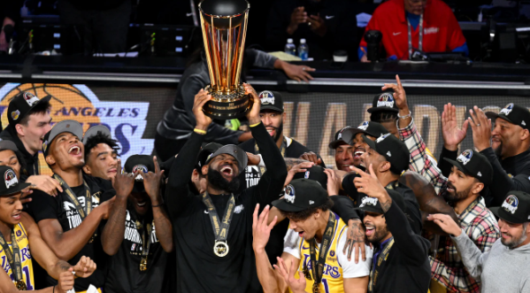 LeBron James holding up the trophy awarded to the winning team of the first ever NBA in-season tournament. The king added to his already stacked resume.