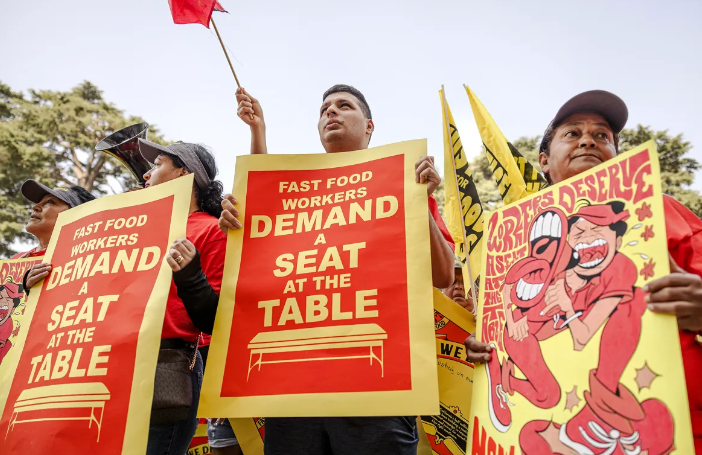 Fast food workers rally for higher wages in Sacramento. Starting in April 2024, the minimum wage for the industry rises to $20 an hour. 