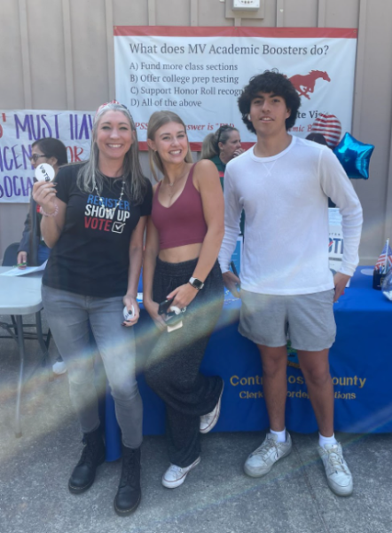 Ms. Hartig poses with two of her students as they pre-register to vote. This event took place earlier this year, but Hartig hopes to get more student turn out in the future.
